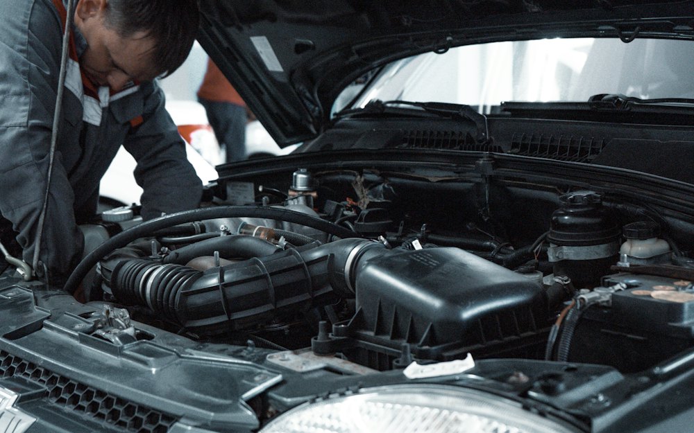 Mechanic checking a car engine in a workshop